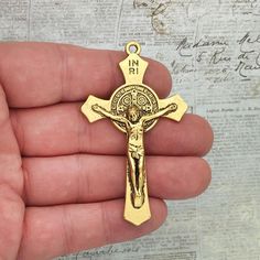 You will receive BULK 3 - Extra Large St Benedict Crucifix Cross Pendant in Antique Gold Pewter 70x41x5mm by TIJC. These charms are a quality Pewter for all your jewelry and crafting projects! - (3) Christian Pendant - 70x41x5mm ( 25.4mm = 1 inch ) - Quality Pewter - Item # SP1675B Use to Make Mens Crucifix Necklace Gold Crucifix Necklace All Items will come as shown in a poly bag! WE ARE LOCATED IN TEXAS. WHICH MEANS YOU RECEIVE ITEMS QUICKLY IF IN THE U.S! WE ALSO SHIP INTERNATIONALLY All item Gold Crucifix Necklace, St Benedict Cross, Jesus Christ Artwork, Crucifix Necklace, St Benedict, Saint Benedict, Police Badge, Cross Jewelry, Poly Bags