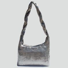 The Polly Bag Street Level Is A Chainmail Metal Mesh Shoulder Style. Chainmail Mesh Has Been Been In Style Throughout Fashion History And Isn't Going Anywhere Anytime Soon. This Bag Has A Zipper Closure At The Top And An Inside *Available In Silver, Gold, Or Black* Zipper Pocket. Interior Features: Single Compartment Exterior Features: Mesh Detail, Twisted Handle G" L 2" W 5" H Silver Rectangular Shoulder Bag With Chain, Formal Silver Shoulder Bag With Chain, Chic Silver Shoulder Bag With Chain, Silver Evening Shoulder Bag With Silver-tone Hardware, Silver Evening Bag With Chain Detail, Silver Rectangular Bags With Chain, Glamorous Silver Shoulder Bag With Chain Strap, Trendy Silver Evening Bag, Formal Silver Bag With Chain