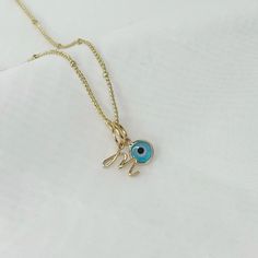 Introducing our exquisite Pyrgos necklace, a blend of style and symbolism. Adorned with a captivating light blue evil eye charm, this necklace is designed to ward off negative energy and bring protection to its wearer. Personalize it with an initial, making it uniquely yours or a thoughtful gift for a loved one. Crafted with care, this necklace is a beautiful expression of both fashion and spirituality. ♡ Handcrafted  ♡ 14K Gold Plated  ♡ Natural Freshwater Pearl ♡ Water Resistant ♡ 40cm Length Dainty Initial Necklace With Charms For Gift, 14k Gold Necklaces With Initial Pendant Charms, Dainty Initial Pendant Necklace With Charms, Minimalist Initial Necklace With Charms As Gift, Minimalist Name Necklace With Initial Pendant And Charms, Minimalist Name Necklace With Initial Pendant, Gold Plated Initial Necklace With Delicate Chain, Dainty Adjustable Initial Pendant Necklaces, Spiritual Gold Plated Initial Pendant Necklaces