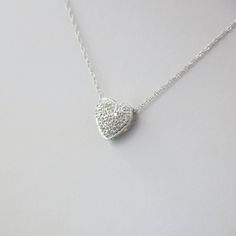 Single cut diamonds are pave set into this 14k white gold heart pendant. A Singapore white gold chain is the perfect addition to complete this necklace. Metal: 14K White Gold Necklace Length: 16 Inches Pendant Length x Width: 3/8 x 3/8 Inches Diamonds: .17 CTW, SI1 E-F For a greater selection of jewelry please visit our website at www.BlackMarketLLC.com If you have any questions about this product or if we can help you with any of our other products please contact us through Etsy or our website White Diamond Necklace With Single Cut Heart Shaped Diamonds, Heart Cut Pave Diamond Wedding Necklace, White Gold Heart-shaped Necklace With Pave Setting, White Gold Heart Shaped Diamond Necklace With Brilliant Cut, Heart-shaped Brilliant Cut White Gold Diamond Necklace, Heart Cut Diamond Necklace With Pave Setting For Wedding, White Gold Heart Cut Necklace With Pave Setting, Wedding Heart Cut Diamond Necklace With Pave Setting, Heart Shaped Brilliant Cut White Gold Diamond Necklace