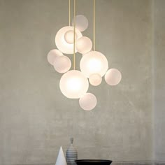 a chandelier hanging from the ceiling in a room with white walls and flooring