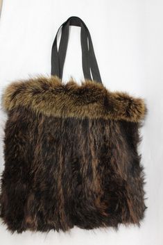 "RACCOON FUR TOTE STYLE BAG!  THIS ITEM IS SCRAP: THE FUR IS RIPPED BUT THE GOOD PART CAN BE USED FOR FUR ACCESSORY PROJECET! MEASUREMENT: SIZE 14\"(HEIGHT) X 14\"(WIDTH)  STRAP LENGTH: 22\" a10169 Oliverfurs 9250 Parc Ave. #204, Montreal, Quebec, H2N 1Z2, Canada www.oliverfurswholesale.com oliver@oliverfurswholesale.com Toll free: 1-866-845-9997 International: 1-514-845-9997" Fur Clutch Bag, Rock Star Outfit, Fox Fur Scarf, Fur Clutch, Faux Fur Purse, Faux Fur Bag, Fur Purse, Fur Headband, Fur Wrap