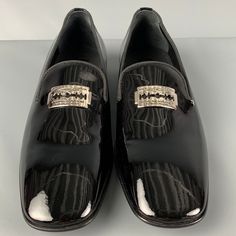 John Richmond Loafers Comes In A Black Patent Leather Featuring A Silver Tone Razor Blade Detail, Slip On, Square Toe, And Includes A Size: 13 Color: Black Pattern: Solid Fabric: Leather Type Of Leather: Patent Leather Style: Slip On Made In: Italy Designer Slip-on Dress Shoes For Formal Occasions, Black Slip-on Dress Shoes For Formal Occasions, Sleek Black Loafers With Leather Sole, Formal Patent Leather Slip-on Shoes, Elegant Moc Toe Formal Dress Shoes, Elegant Moc Toe Dress Shoes For Formal Occasions, Elegant Formal Dress Shoes With Moc Toe, Classic Plain Toe Loafers For Party, Luxury Leather Shoes With Round Toe For Party