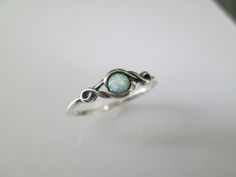 Opal infinity ring. So adorable is this solid sterling silver opal ring. A nice little dainty opal ring. The fiery lab opal is bursting with color, and is set between two swirling loops...similar to an infinity design. Face height = 6mm. Stamped 925. KEEP*IN*TOUCH FOLLOW and LIKE us on www.facebook.com/jkcorpjewelrycollection www.instagram@jkcorpjewelrycollection Thank you for visiting our shop! Sterling Silver Stackable Infinity Jewelry, Sterling Silver Infinity Stackable Rings As Gift, Gift Sterling Silver Infinity Stackable Rings, Sterling Silver Infinity Stackable Rings, Sterling Silver Infinity Ring, Sterling Silver Infinity Ring Gift, Sterling Silver Birthstone Infinity Ring, Hypoallergenic Silver Birthstone Ring In Sterling Silver, Handmade Infinity Promise Ring