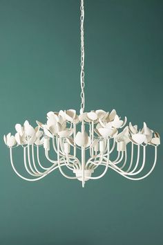 a chandelier with white flowers hanging from it