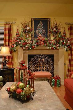 a living room decorated for christmas with ornaments and decorations on the fireplace mantels