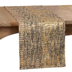 the table runner is made from natural wood and has an intricate pattern on it, along with