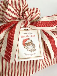 a red and white striped present wrapped in ribbon