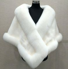 a white fur cape on a mannequin dummy