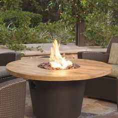 a fire pit sitting on top of a wooden table