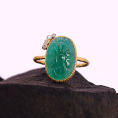 This Natural Carved Emerald Diamond Ring is a true treasure that combines the timeless elegance of emerald with the brilliance of diamonds. Crafted with utmost precision, this ring features a stunning emerald gemstone that has been intricately carved to enhance its natural beauty. The emerald's deep green hue adds a touch of sophistication and symbolism, making it not only visually captivating but also the perfect gift for someone born in May, as emerald is the birthstone for this month.  This R Oval Emerald Ring With Single Cut Diamonds, Heirloom Oval Emerald Ring With Single Cut Diamonds, Emerald Rings With Single Cut Diamonds For Gifts, Green Oval Diamond Ring With Single Cut, Green Oval Single Cut Diamond Rings, Hallmarked Emerald Diamond Ring For May Birthstone, Luxury Round Emerald Ring With Stone Setting, Luxury Oval Emerald Ring With Stone Setting, Fine Jewelry Emerald Ring With Stone Setting