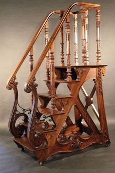 an ornate wooden staircase with spindles and handrails in the shape of a clock