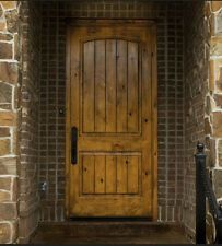 a wooden door sitting on the side of a stone building