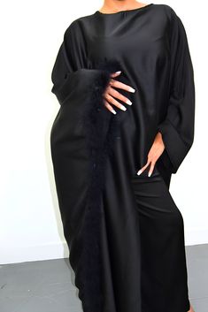 Embrace timeless elegance with our exquisite Satin Abaya Co-Ord Set. This stunning two-piece ensemble features a luxurious, soft-flowing satin fabric that drapes beautifully and flatters your figure. The elegant abaya boasts a modest silhouette, perfect for everyday wear or special occasions. The highlight of this set is the exquisite fur trim. This touch of luxury adds a touch of sophistication and warmth to the design, making it perfect for cooler evenings or formal events. Key Features Luxurious Satin Fabric: Experience the soft, smooth feel of premium satin that flatters your form. Elegant Abaya Silhouette: This modest design offers full coverage while maintaining a stylish and graceful drape. Delicate Fur Trim: Elevate your look with a touch of luxury and warmth. Two-Piece Co-Ord Set: Chic Long Abaya For Eid, Elegant Floor-length Abaya For Eid, Elegant Floor-length Satin Set, Elegant Satin Maxi Abaya, Elegant Evening Thobe In Maxi Length, Eid Evening Long Abaya, Satin Floor-length Abaya For Eid, Elegant Long Abaya For Formal Occasions, Modest Long Abaya For Evening