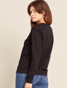 Every capsule wardrobe deserves the essential comfort and style that a high-quality, comfy long sleeve t-shirt provides. With its relaxed-fit silhouette, classic neckline, and long cuffed sleeves, this fit is a reliable everyday essential. Style it according to your destination—whether tucked in for a polished look or left out for casual everyday. Capsule Closet, Sleep And Loungewear, Left Out, Racerback Bra, Basic Long Sleeve, Black Xs, Casual Everyday, Polished Look, Cuff Sleeves