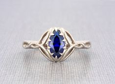 Sterling silver Celtic knot marquise blue sapphire engagement ring  Fusion blue sapphire size 10x5mm approx. marquise shape brilliant excellent cut solid sterling silver sapphire ring for women The ring dimensions are: front width: 12 mm/ 0.47" inch front height above the finger: 4.5mm/0.17" inch approx. side thickness: 1.7mm/0.06" inch side width: 3mm/0.11"inch back thickness: 1.4mm/0.05" inch back width: 2.4mm / 0.09" inch approx.   💎 OUR SHOP💎  https://www.etsy.com/shop/ClanTora 💍 RING 💍 Fine Jewelry Marquise Sapphire Promise Ring, Marquise Sapphire Promise Ring Jewelry, Marquise Sapphire Promise Ring, Marquise Sapphire Promise Ring In White Gold, Gift Marquise Sapphire Ring, Gift Marquise Diamond Cut Sapphire Ring, Marquise Diamond Cut Sapphire Ring Gift, Sapphire Marquise Promise Ring, Marquise Sapphire Ring As Gift