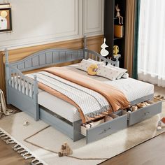 a bed with two drawers underneath it in a room next to a rug on the floor