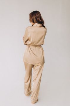 This women pajama is made of high-quality silk on a cotton base, making it pleasant to the touch and comfortable to wear in any season. The set includes classic loose-fitting pants with an elastic waistband and a button-up shirt that is lined with the same fabric. The pajama is decorated with trim and features a breast pocket on the shirt. The women's pajama comes with a belt, and the length of the pants, sleeves, and other measurements are customized for each client as the garment is tailored t Chic Loungewear Sets With Elastic Waistband, Chic Beige Sleepwear For Loungewear, Elegant Relaxed Fit Sleepwear Long Pants, Satin Pajamas Set, Loose Fitting Pants, Fitting Pants, Garment Steamer, Beige Style, Satin Pyjama Set