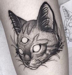 a black and white cat with glowing eyes on the leg, by tattoo artist person