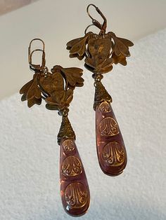 Vintage Czech Art Nouveau Earrings Circa 1920-1930's from the Czech Republic.  This vintage piece is made with brass and Czech glass which is cast into molds and fashioned into pieces of jewelry.  The pieces I have listed for sale have natural wear from time as they are not reproductions.   The earrings measure 5 inches and weighs .7 oz. each (with a lever back closure measuring 3/4 inch). Thank you for looking! Vintage Ceremonial Drop Earrings, Vintage Drop Earrings For Ceremonial Occasion, Vintage Brass Earrings For Ceremonial Occasions, Victorian Brass Earrings For Ceremonial Use, Victorian Brass Earrings For Ceremonial Occasions, Victorian Gold Plug Earrings, Vintage Brass Clip-on Earrings For Gift, Vintage Handmade Brass Clip-on Earrings, Antique Dangle Plug Earrings