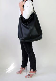 Black leather hobo This black large tote bag is made from high quality italian leather. Spacious interior provides room for all the daily essentials and more. There is an inside zippered pocket. This bag is perfect as your everyday bag, which can fit an IPAD, laptop, A4 files, books, magazines, cosmetic bag as well as many accessories. This bag has top zipper closure for safety. Height: 18,5 inch (47 cm) Width: 18,1 inch (46 cm) Length of handle: 19,3 inch (49 cm) Bottom width: 13,4x 5,5 inch (3 Modern Black Hobo Bag For Everyday, Everyday Large Capacity Black Hobo Bag, Versatile Black Hobo Bucket Bag, Black Canvas Hobo Bag For Daily Use, Versatile Black Hobo Bag For Everyday, Versatile Black Hobo Bag, Black Leather Hobo Bag For Daily Use, Black Hobo Bag With Large Capacity, Black Hobo Bag With Removable Pouch For Everyday