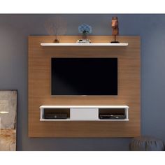 an entertainment center with a flat screen tv mounted on the wall