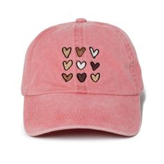 a pink hat with hearts embroidered on it