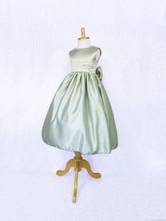 A classic and simple but beautiful full satin dress that's perfect for any formal occasion: weddings, graduations, birthdays, or holidays! Handcrafted with the upmost of care and attention to detail, we make sure that each dress is perfectly one of a kind for your little girl. Comfortable satin material covers the dress from shoulder to hem. The sleeveless top has a zipper on the back for closure. Comes with a detachable matching bow with tails. The skirt has a layer of lining underneath with at Satin Finish Bridesmaid Dress, Sleeveless Satin Princess Dress, Green Satin Finish Bridesmaid Dress, Satin Princess Bridesmaid Dress, Princess Style Satin Bridesmaid Dress, Princess Satin Bridesmaid Dress, Sleeveless Satin Princess Dress For Pageant, Sleeveless Satin Princess Wedding Dress, Elegant Wedding Princess Dress