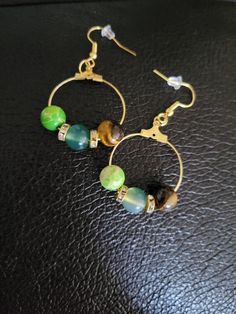 Check out this item in my Etsy shop https://www.etsy.com/listing/1252018752/green-jade-emperor-bead-and-tigers-eye Hoop Earrings With Round Natural Stones For Gift, Round Beads Earrings For Jewelry Making, Adjustable Beaded Earrings With Natural Stones For Gift, Round Beads Earrings With Natural Stones For Jewelry Making, Adjustable Beaded Earrings With Natural Stones, Adjustable Hoop Earrings With Natural Stones, Hypoallergenic Round Spiritual Earrings, Hypoallergenic Nature-inspired Round Earrings, Spiritual Hypoallergenic Round Earrings