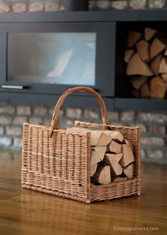 a wicker basket sitting on top of a wooden floor in front of a tv