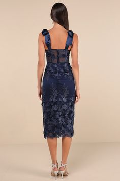 The Lulus Exquisite Charisma Navy 3D Floral Bustier Tie-Strap Midi Dress is the perfect pick for those occasions where you want to look effortlessly lovely! A sheer mesh overlay boasts intricate embroidery and three-dimensional floral appliques as it shapes a bustier-inspired bodice with sheer panels (along with padded cups, no-slip strips, and supportive boning) and a flirty sweetheart neckline, all supported by long satin tying straps. The high, fitted waist tops a figure-skimming column skirt 3d Floral Dress, Floral Bustier, Column Skirt, Corset Bustier, Intricate Embroidery, Mesh Overlay, Floral Applique, Sweetheart Neckline, Appliques