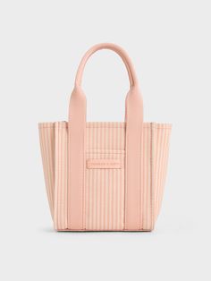 This product is made with at least 20% sustainable materials by weight. CHARLES & KEITH uses recycled, degradable, organic, and water-based materials in our eco-conscious collection.The new season brings back the Kay in brand-new sizes and colours -- like this striped version in eye-catching pink. This mini bag is perfect for casual days out and vacations -- compact and functional, it makes for a great travel companion, and will fit into your carry-on suitcases without taking up much space. It w Striped Tote Bag, Latest Bags, Carry On Suitcase, Charles Keith, Pink Mini, Travel Companion, Phone Wallet, Suitcases, Eco Conscious