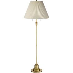 a gold floor lamp with a white shade on the base and a beige lampshade