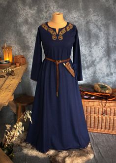 This Early Medieval wool dress is universal for the Vikings and Slavs or any other reenactors. Based on medieval iconography and archaeological finds from Europe. The dress has two wide wedges on the both sides, sewn a few centimetres over the hips. The dress reaches the ground, has a simple body and long tapering sleeves which are sewn to the body at right angles. The dress' circumference is about 2 meters. The split neckline is embellished entirely with hand-embroidered 100% silk thread. Patte Traditional Medieval Festival Costume Dresses, Traditional Medieval Dress For Medieval Festivals, Traditional Medieval Dress For Ceremonial Use, Traditional Medieval Dress For Ceremonial Events, Traditional Fitted Medieval Dress, Traditional Long Sleeve Dresses For Medieval Festivals, Traditional Medieval Dress For Ceremonial Occasions, Traditional Medieval Dress For Larp And Festivals, Traditional Medieval Dress For Larp And Medieval Festivals