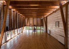 an empty room with wooden walls and flooring is shown in this image from the inside