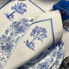 the blue and white table cloths are next to silverware