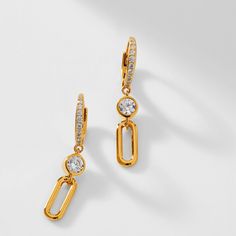 ABOUT THE PRODUCTPave CZ adorns these dainty drop chain link earrings, embellished by either clear CZ stone or Ruby-colored stone for a pop of sparkle and color. Metal: Sterling Silver Plating: 18KT Gold, Rhodium, or Rose Gold Stones: Cubic Zirconia, Ruby Synthetic Corundum Length: 3/4 in Width: 1/4 in Chain Link Earrings, Link Earrings, Colored Stone, Leverback Earrings, Cz Stone, Chain Link, Or Rose, Sterling Silver Earrings, Silver Color