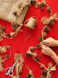 someone is working on some burlap and pine cones