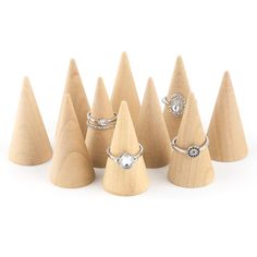 six wooden cones with rings on them and one has a diamond ring in the middle