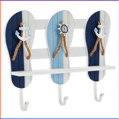 two blue and white surfboard shaped hooks with rope on each hook, one holding a clock