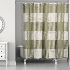 a green and white shower curtain in a bathroom