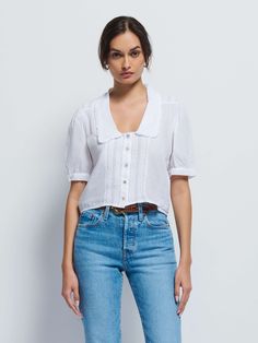 This one is all about the details. Ruffle-edged collar, subtle puff sleeves, shoulder and center pintucks, keyhole sleeve openings, and delicate shell buttons throughout to top it all off with a little vintage charm. (This one comes in White.) | Women's Pia Blouse Top in White | Ethical Essentials Short Sleeve Tops With Pintucks For Daywear, Classic Cotton Top With Ruffled Collar, Classic Fitted Puff Sleeve Top For Summer, Classic Puff Sleeve Shirt With Relaxed Fit, Classic Shirt With Puff Sleeves In Relaxed Fit, Cotton Tops With Pintucks For Daywear, Classic Tops With Button Closure And Ruffled Collar, Classic Tops With Ruffled Collar And Button Closure, Classic Cotton Blouse With Peter Pan Collar