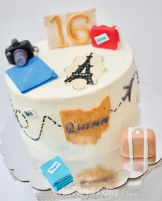 a birthday cake with the number sixteen on it's side and travel themed decorations