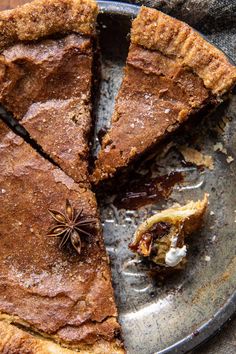 a chocolate pie on a plate with a bite taken out of it and the rest of the pie is missing