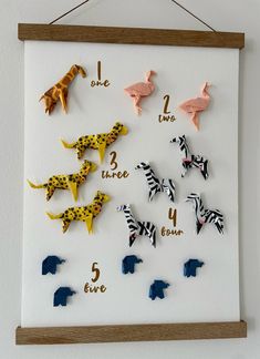 there are many different animal magnets on the wall with numbers and letters in them