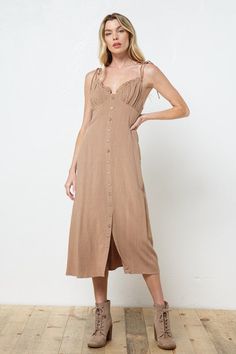 Button down midi dress with ruffle detail, smocked back, bow tie details on shoulders. 70% Rayon 30% Linen. S: 4-6 M: 8-10 L: 10-12 Midi Dress With Smocked Back For Date Night, Summer Smocked Midi Dress With Tie Straps, Date Night Midi Dress With Tie Straps, Chic Midi Dress With Smocked Back For Casual Wear, Chic Midi Dress With Tie Straps For Day Out, Sundress Midi Dress With Smocked Back For Date Night, Dress Down Midi Dress With Smocked Back, Spring Smocked Midi Dress With Tie Straps, Spring Button-up Ruffle Dresses