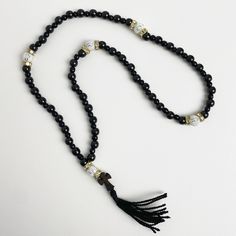 "50 beads rosary made of black jasper. The Orthodox prayer beads are crafted from the natural stone \"Gagat,\" renowned since ancient times for its protective and healing properties. It is alternatively known as \"Black Jasper\" or \"Black Amber.\" Splitting beads from the wood species \"Boxwood\" - which is one of the hardest wood species. Orthodox black rosary will be an amulet and protector of its owner, used for counting the prayers read or other ritual actions, preserving attention and concentration, the task of rhythm, massage nerve endings located on the fingertips, associated with the nervous system of man.  ★ Length of the rosary: 13.78 in (35 cm) ★ Bead diameter: 0.23~0.11 in (6~3 mm) ★ Number of beads: 50+5 pcs (50 gagat beads, 5 boxwood beads) ★ Dimensions of the cross: 0.69 in Adjustable Rosary With Polished Beads For Meditation, Adjustable Polished Beads Rosary For Meditation, Black Wooden Beads For Meditation, Adjustable Black Spiritual Rosary, Black Wooden Beads Rosary Spiritual Style, Black Wooden Beads Rosary, Black Wooden Beads Spiritual Rosary, Adjustable Black Rosary With 8mm Beads, Gift Black Rosary With 8mm Beads