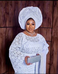 White lace iro and buba White Lace Iro And Blouse Styles, Iro And Blouse Lace Styles Latest 2024, Oleku Iro And Buba Styles Lace, Buba And Wrapper Styles, Elegant Lace Sleeves Dress For Ceremony, Elegant Lace Dress With Lace Sleeves For Ceremonies, Elegant Lace Sleeve Dress For Ceremony, White Lace Dress With Lace Cuffs For Party, Elegant Lace Dress With Crochet Details