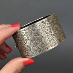 "A stunning silver cuff with floral engraving dating to the Edwardian era (1901-1915). This piece is a mix of the classic and the unusual - classic in its use of floral emblems; and unusual for its extra wide design. It is also in exceptionally good condition for its age, with only minor wear - something seldom found in pieces of this kind. Fully stamped for sterling silver, Birmingham, 1901, maker's mark 'B.H.J.' (B.H. Joseph & Co.). Measurements (approximate): 36mm (1.4\") wide. Internal diameter is 58mm (2.3\") x 48mm (1.9\"). Fits a small to medium wrist. Weight (approximate): 40.1g Condition: Very good, with minor wear commensurate with age. One of the best examples of its kind that I have seen, with minimal dents and scratches. Engraving and stamps are all crisp. Closure functions we Luxury Silver Etched Bangle, Antique Engraved Cuff Bracelet For Formal Occasions, Classic Wedding Cuff Bracelet With Intricate Design, Ornate Stamped Bracelets For Formal Occasions, Antique Engraved Wide Band Jewelry, Victorian Etched Cuff Bracelet For Formal Occasions, Antique Wide Band Engraved Jewelry, Victorian Engraved Cuff Bracelet For Ceremonial Occasion, Classic Engraved Ceremonial Cuff Bracelet