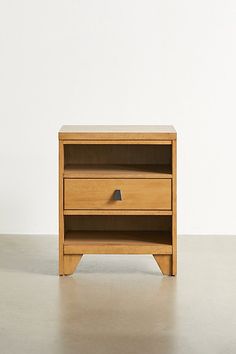 a small wooden table with two drawers on one side and an open drawer on the other